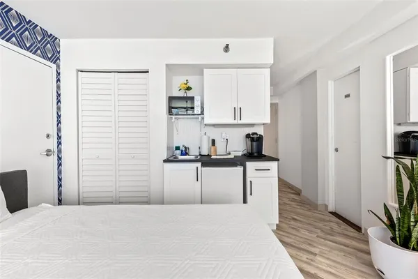 a kitchen with a refrigerator and a stove top oven
