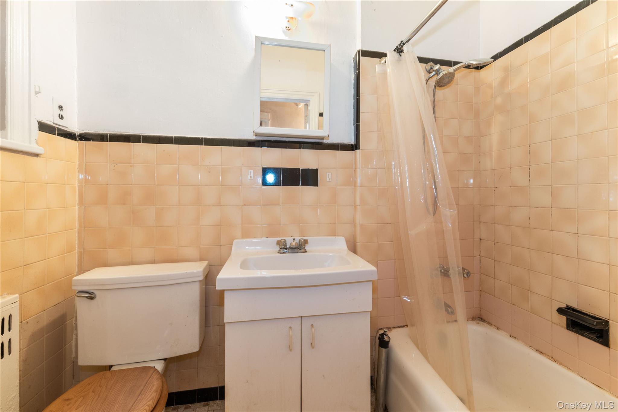 82-72 88th Place Queens, NY 11421 - Photo 11 of 26 a bathroom with a sink a toilet and shower
