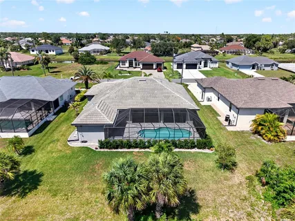 an aerial view of a house with a yard