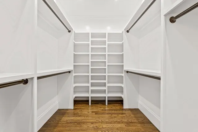 a view of walk in closet with empty racks
