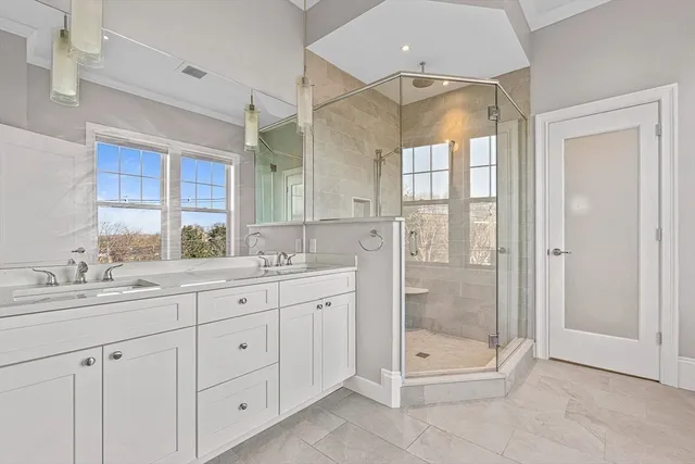 a bathroom with a shower sink and mirror
