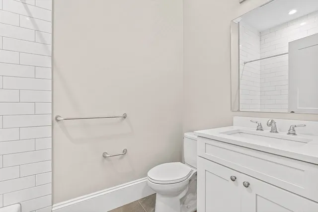 a bathroom with a sink toilet and vanity