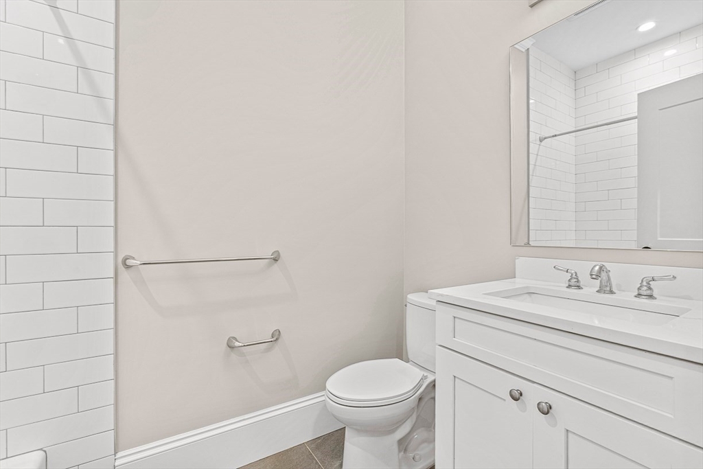 846 Main Street, Unit 3 Winchester, MA 01890 - Photo 19 of 36 a bathroom with a sink toilet and vanity