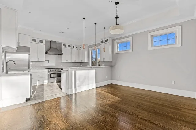 a kitchen with stainless steel appliances granite countertop a sink and a refrigerator