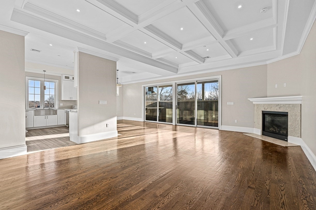 846 Main Street, Unit 3 Winchester, MA 01890 - Photo 2 of 36 a view of an empty room with wooden floor and a fireplace