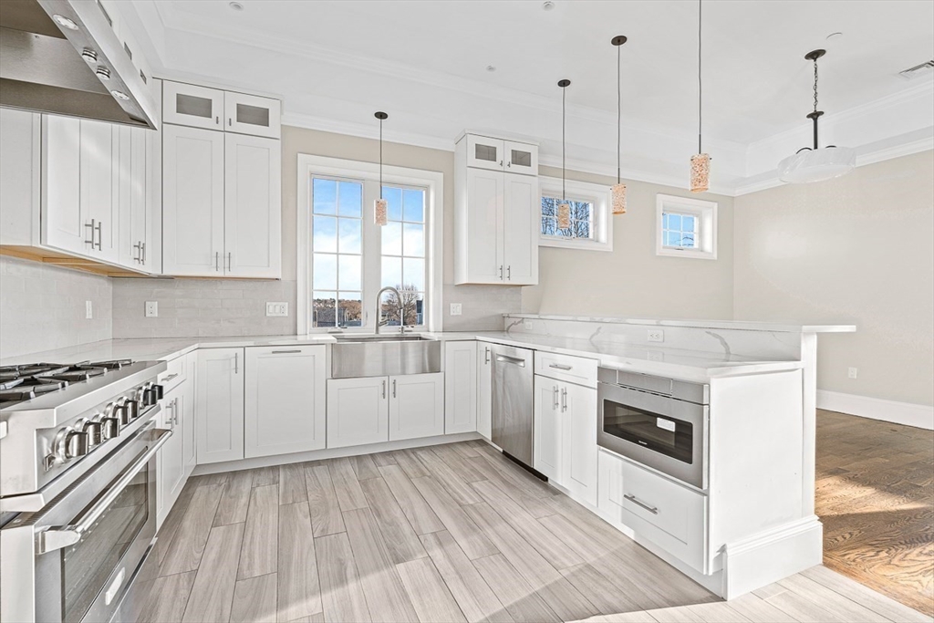 846 Main Street, Unit 3 Winchester, MA 01890 - Photo 23 of 36 a kitchen with a stove oven and white cabinets