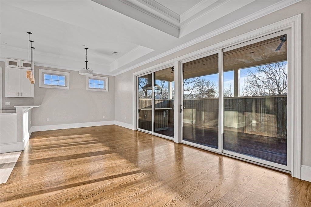 846 Main Street, Unit 3 Winchester, MA 01890 - Photo 28 of 36 a view of empty room with wooden floor and floor to ceiling window