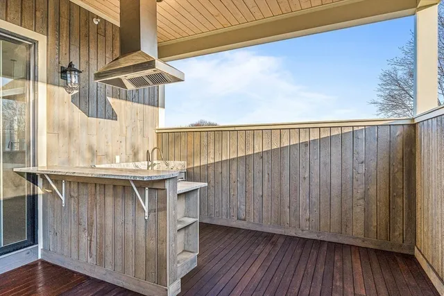 a view of balcony with wooden floor and fence