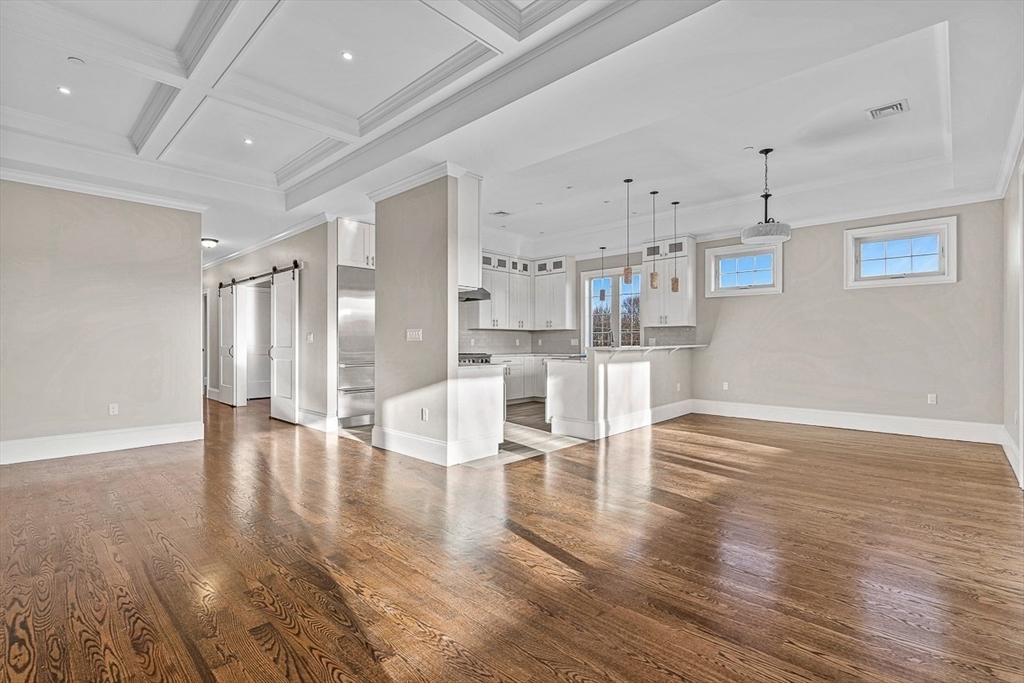 846 Main Street, Unit 3 Winchester, MA 01890 - Photo 3 of 36 a living room with wooden floor and white walls