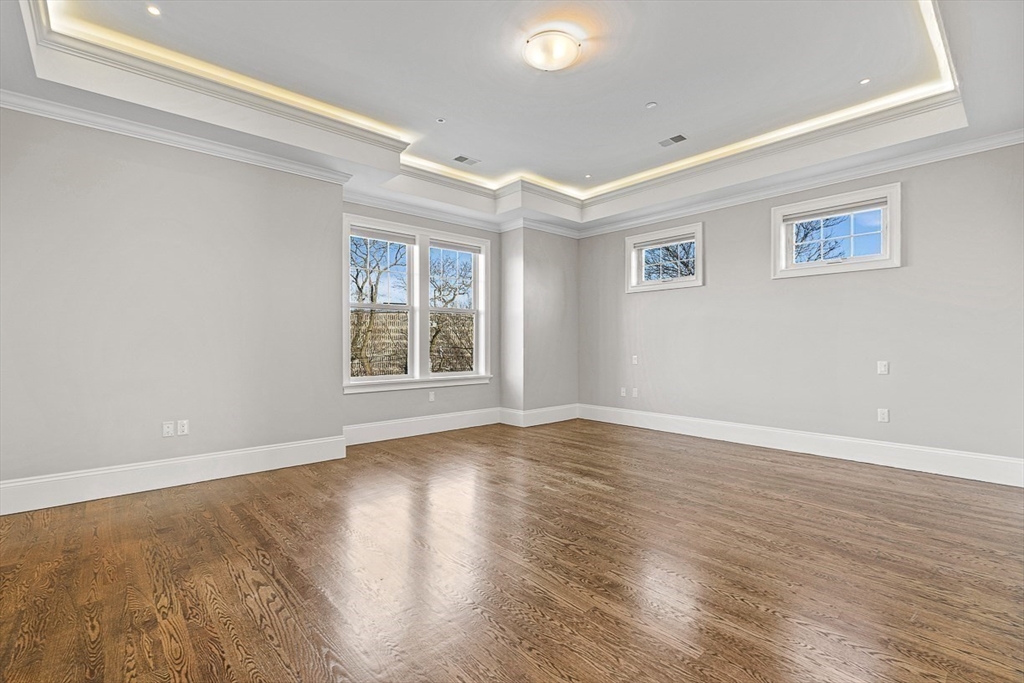 846 Main Street, Unit 3 Winchester, MA 01890 - Photo 8 of 36 a view of an empty room with wooden floor and a window