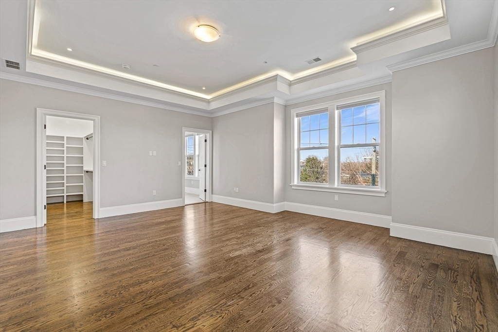846 Main Street, Unit 3 Winchester, MA 01890 - Photo 10 of 36 wooden floor in an empty room with a window