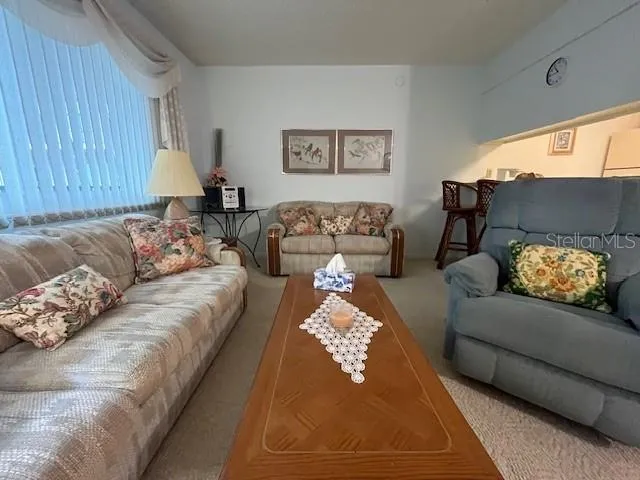 a view of a dining room with furniture and a potted plant