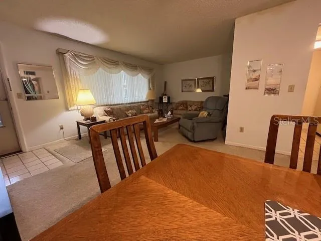 a view of a swimming pool with a patio and a yard