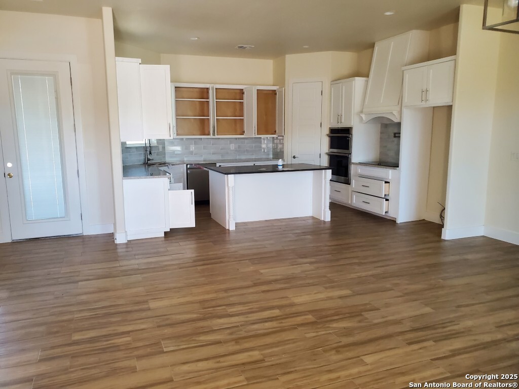 65 Nine Patch Drive Poteet, TX 78065 - Photo 2 of 14 a kitchen with stainless steel appliances granite countertop a stove and a refrigerator