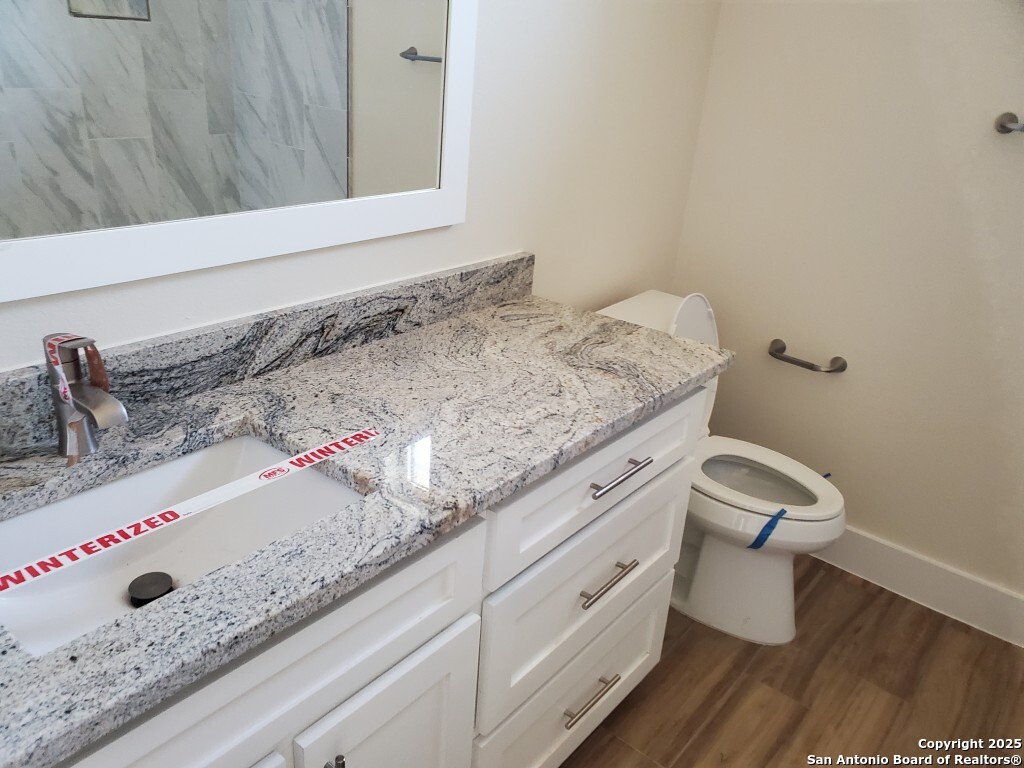 65 Nine Patch Drive Poteet, TX 78065 - Photo 6 of 14 a bathroom with a granite countertop sink and a mirror