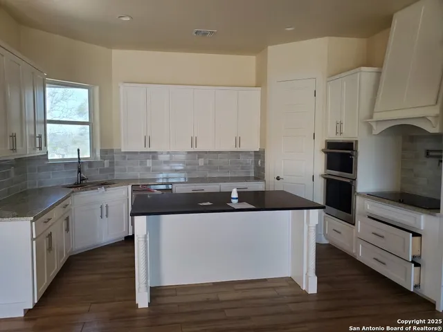 a kitchen with stainless steel appliances granite countertop a stove and a sink