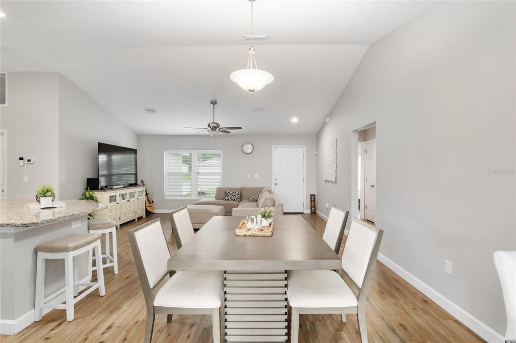 12 Oak Circle Pass Ocala, FL 34472 - Photo 15 of 50 a view of a dining room with furniture wooden floor and chandelier