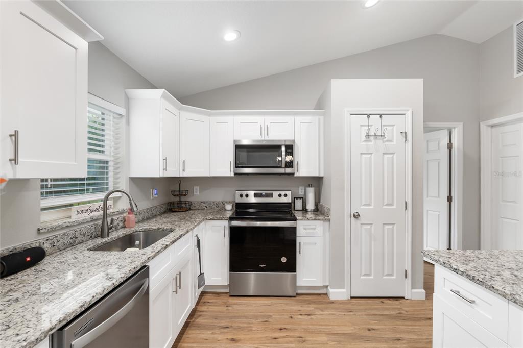 12 Oak Circle Pass Ocala, FL 34472 - Photo 17 of 50 a kitchen with stainless steel appliances granite countertop a stove sink and refrigerator