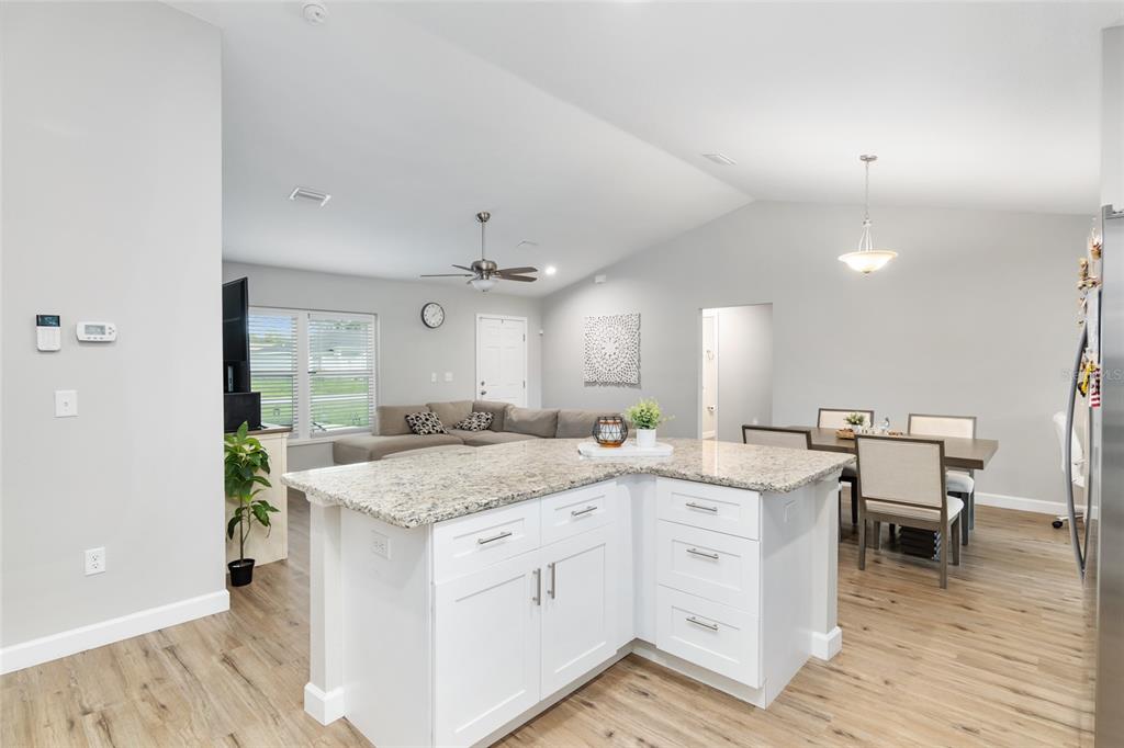 12 Oak Circle Pass Ocala, FL 34472 - Photo 22 of 50 a kitchen with a stove a sink a dining table and chairs