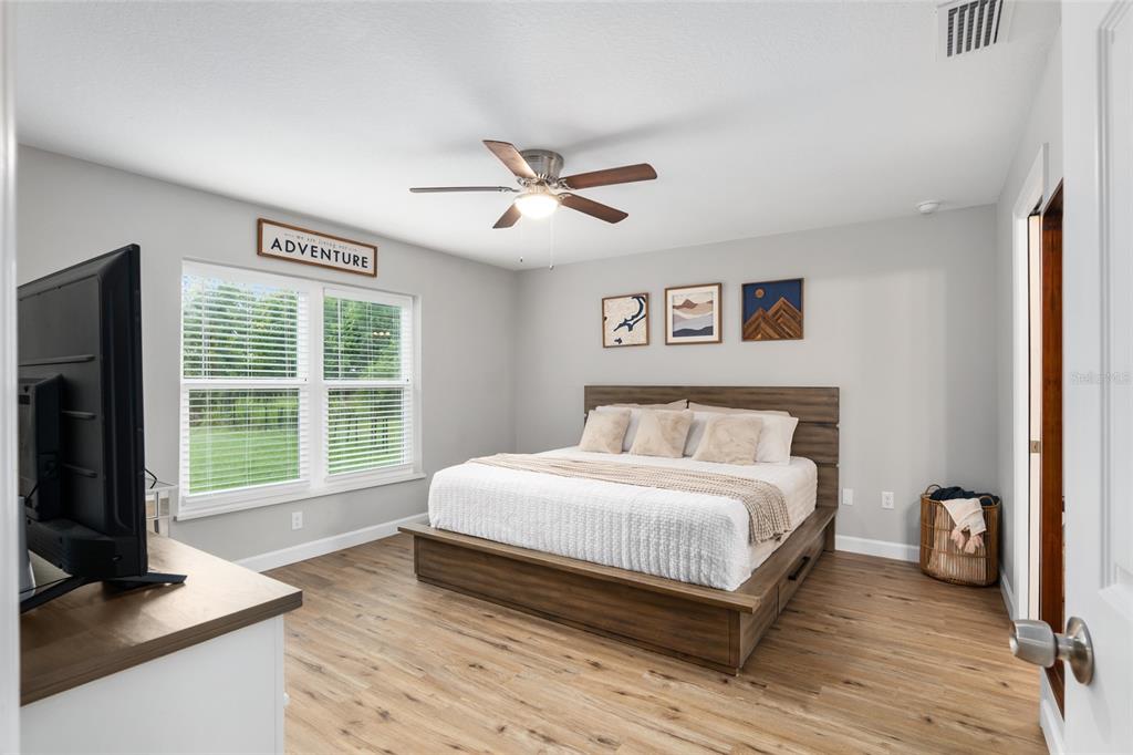 12 Oak Circle Pass Ocala, FL 34472 - Photo 24 of 50 a bedroom with a large bed and a large window