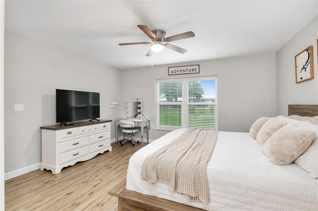 12 Oak Circle Pass Ocala, FL 34472 - Photo 25 of 50 a bedroom with a bed and a flat screen tv
