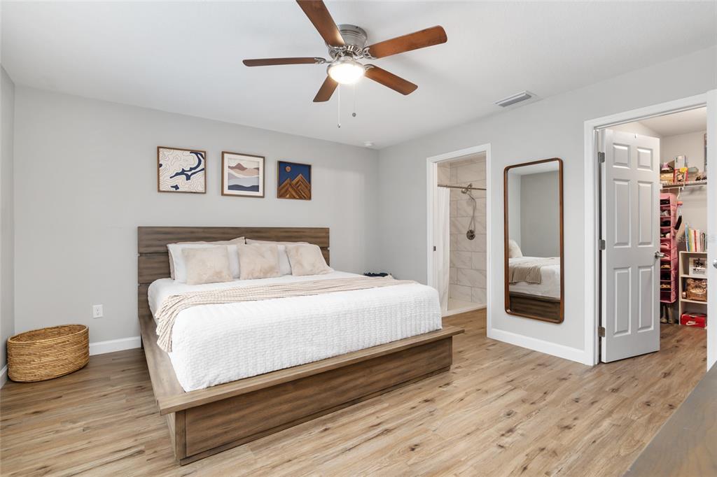 12 Oak Circle Pass Ocala, FL 34472 - Photo 26 of 50 a bedroom with a bed and a chandelier