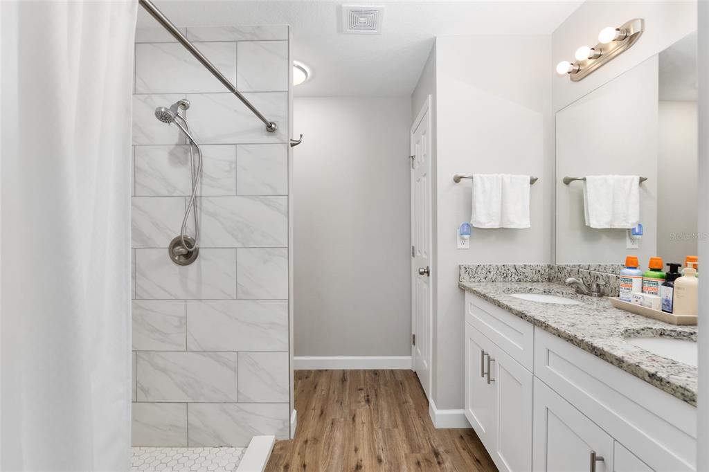 12 Oak Circle Pass Ocala, FL 34472 - Photo 27 of 50 a bathroom with a granite countertop sink a mirror and shower