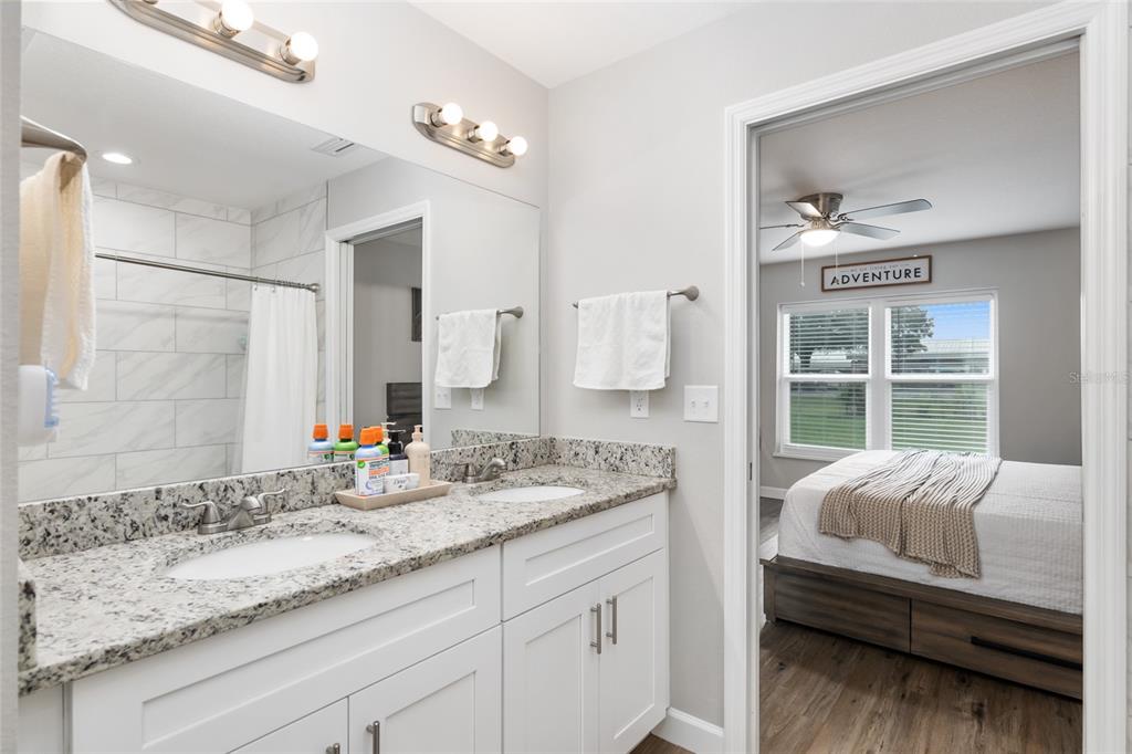 12 Oak Circle Pass Ocala, FL 34472 - Photo 28 of 50 a en suite bathroom with a granite countertop sink and a mirror