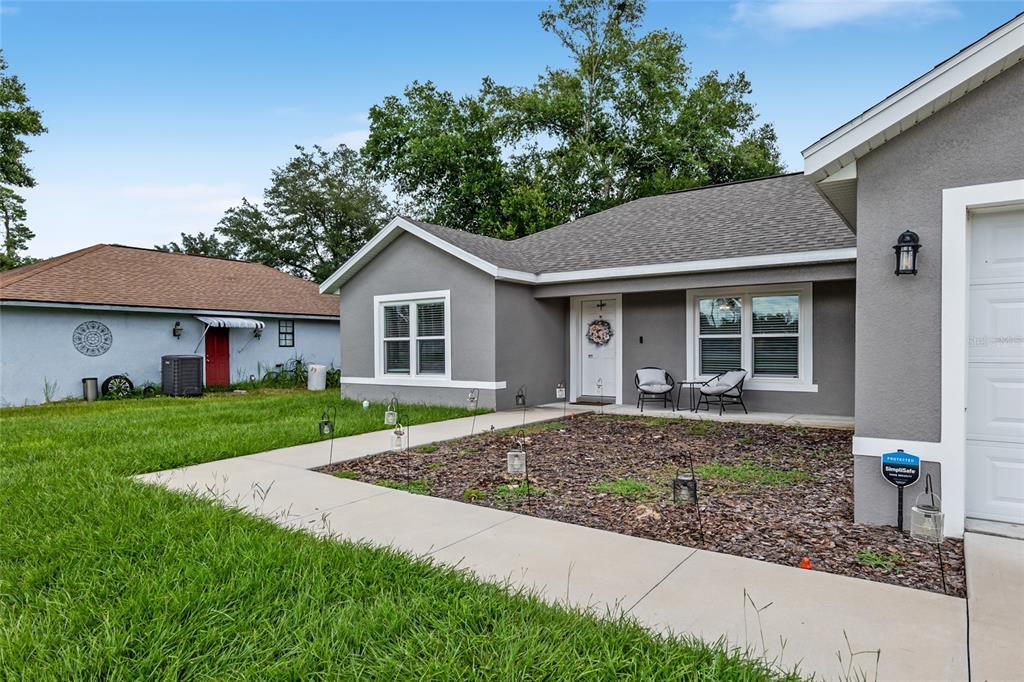 12 Oak Circle Pass Ocala, FL 34472 - Photo 3 of 50 a front view of a house with garden