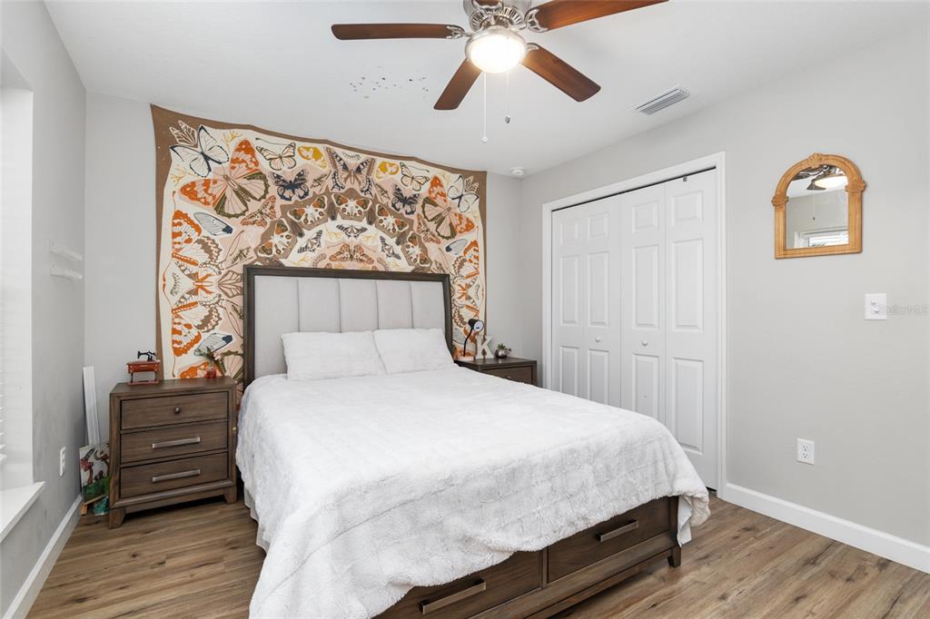 12 Oak Circle Pass Ocala, FL 34472 - Photo 35 of 50 a bedroom with a bed and wooden floor