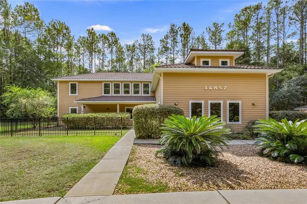 a front view of house with yard and green space