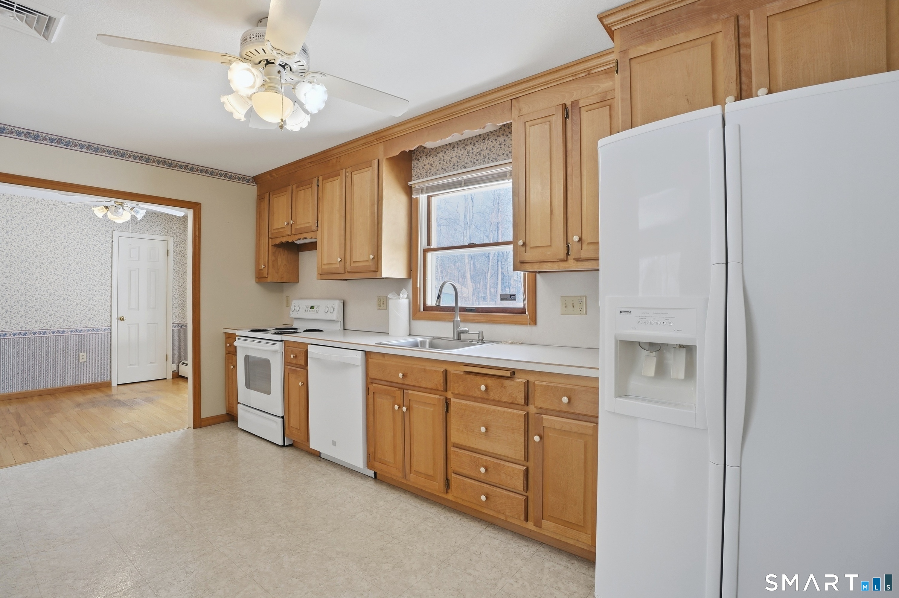 36 Longview Terrace Naugatuck, CT 06770 - Photo 7 of 29 a kitchen with a refrigerator a sink and cabinets