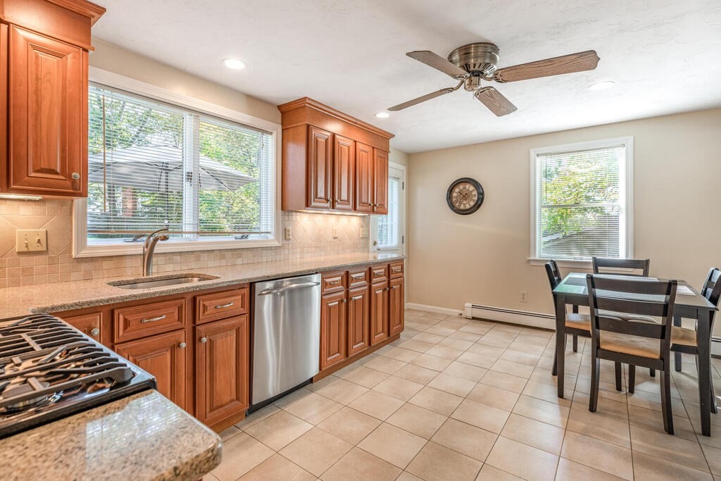 172 Virginia Road Waltham, MA 02453 - Photo 11 of 26 a kitchen with stainless steel appliances granite countertop a stove a sink and a microwave