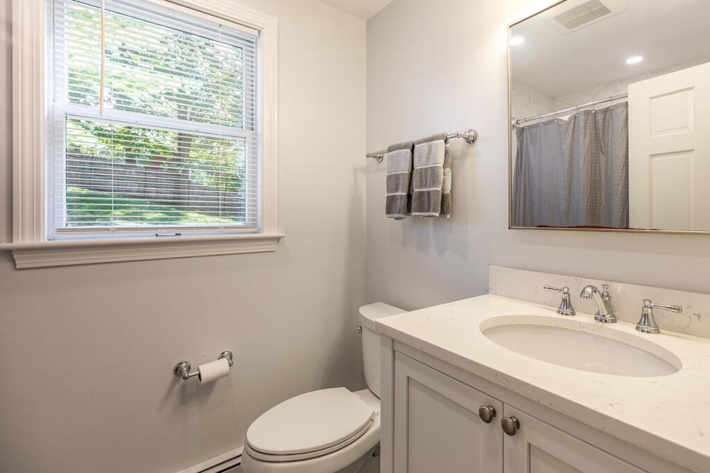 172 Virginia Road Waltham, MA 02453 - Photo 14 of 26 a bathroom with a sink toilet a mirror and shower