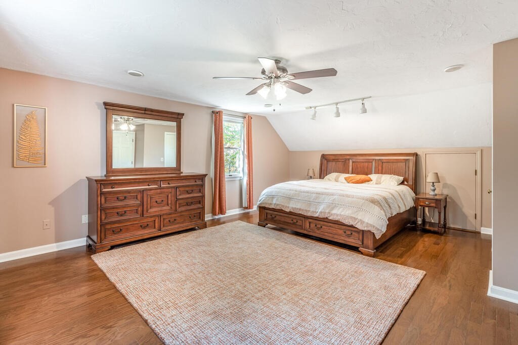 172 Virginia Road Waltham, MA 02453 - Photo 17 of 26 a bedroom with a bed a dresser and painting on the wall