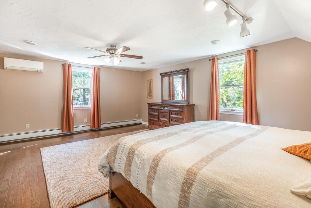 172 Virginia Road Waltham, MA 02453 - Photo 19 of 26 a spacious bedroom with a large bed and a chandelier