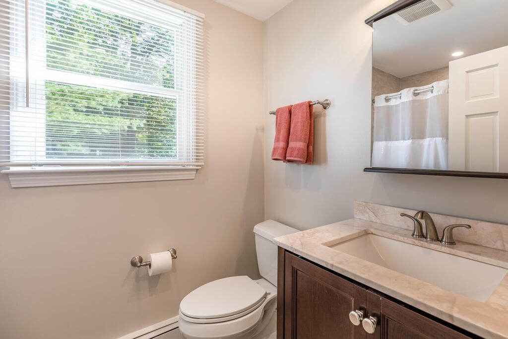 172 Virginia Road Waltham, MA 02453 - Photo 20 of 26 a bathroom with a granite countertop toilet sink and mirror