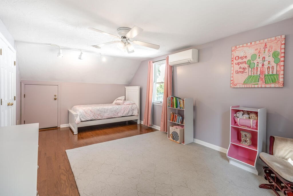 172 Virginia Road Waltham, MA 02453 - Photo 21 of 26 a bedroom with furniture and a chandelier