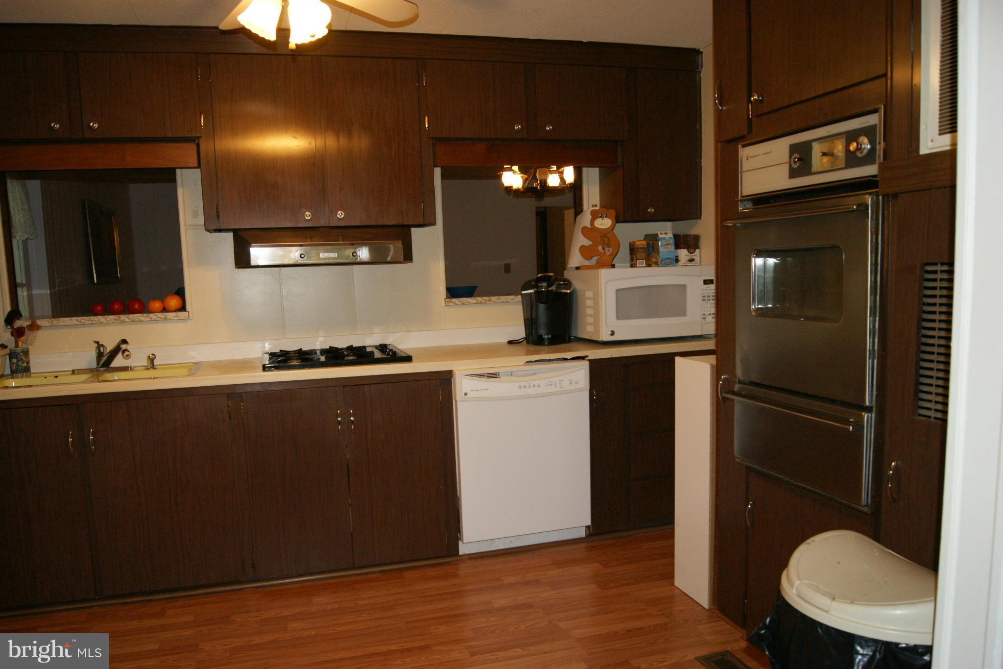 6805 Mackall Road St. Leonard, MD 20685 - Photo 6 of 30 a kitchen with a refrigerator and a sink