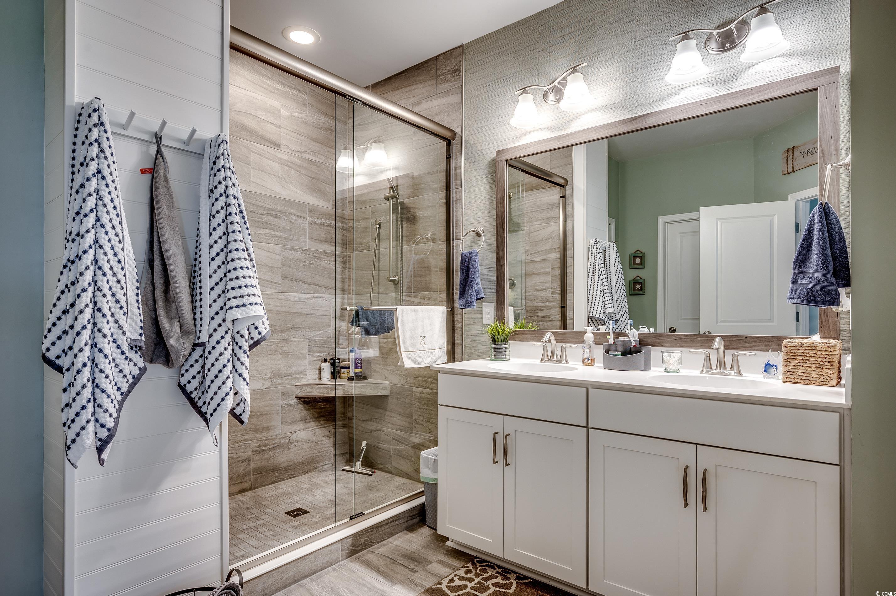 205 Splendor Circle Murrells Inlet, SC 29576 - Photo 16 of 40 Bathroom featuring double vanity, a sink, a stall