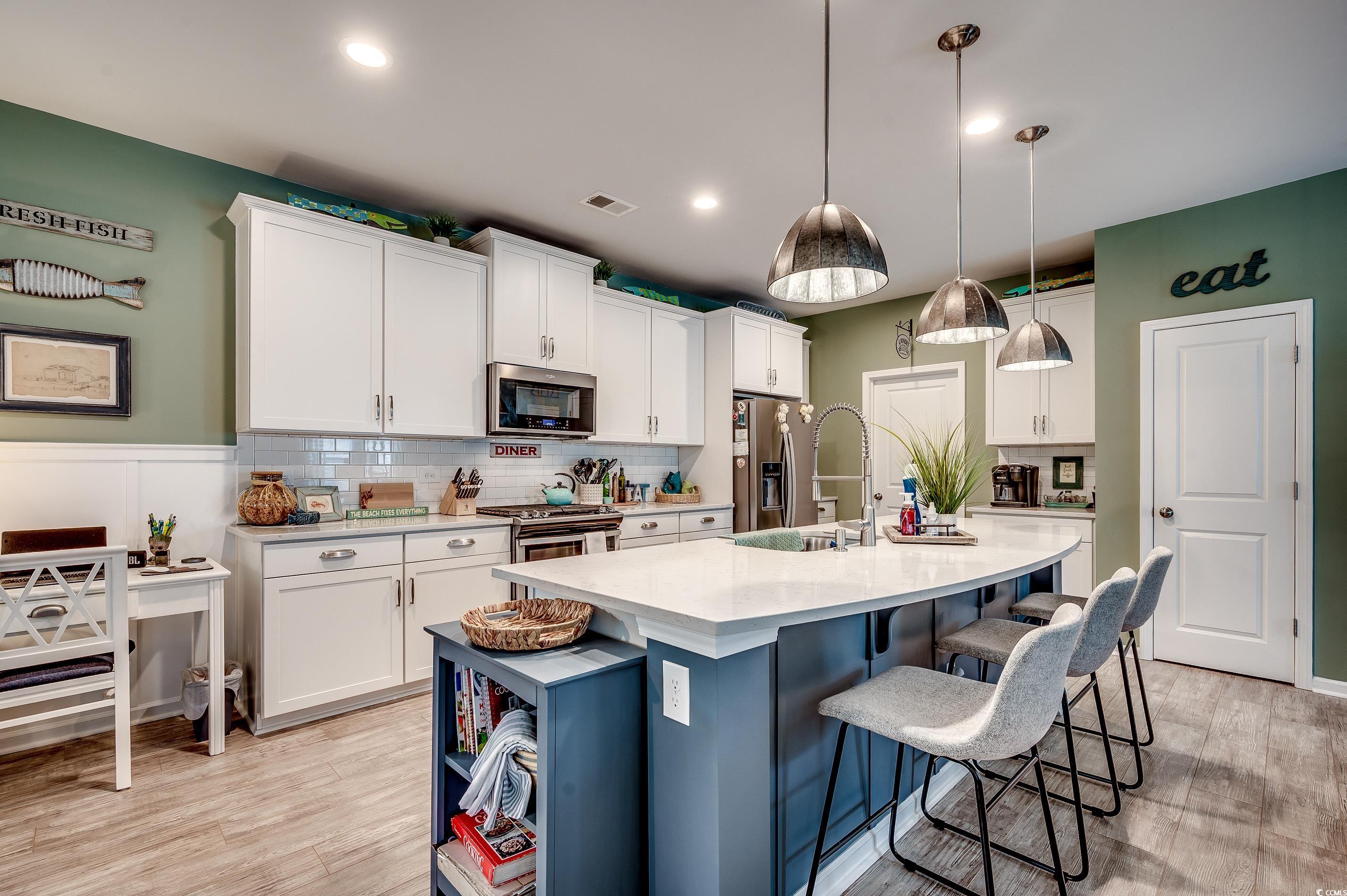 205 Splendor Circle Murrells Inlet, SC 29576 - Photo 8 of 40 Kitchen featuring visible vents, white cabinetry,