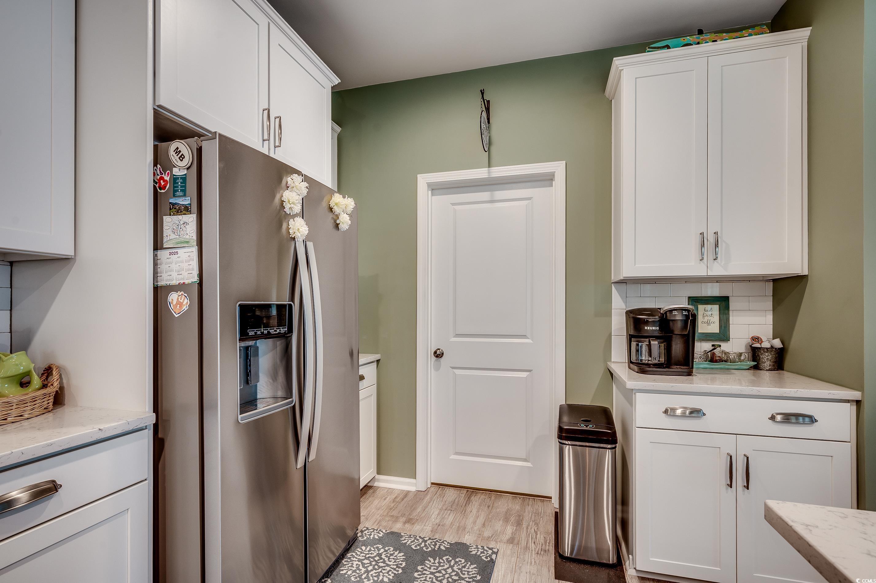 205 Splendor Circle Murrells Inlet, SC 29576 - Photo 9 of 40 Kitchen with light wood-style floors, white cabine