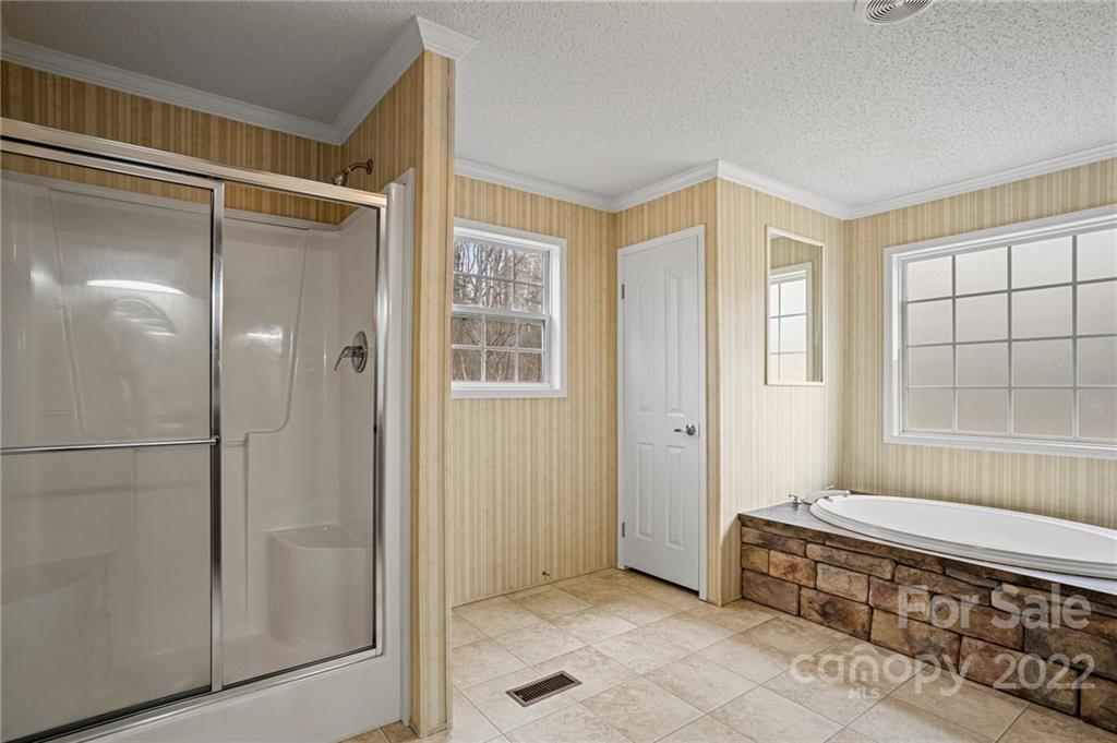 3205 Unity Church Road Lancaster, SC 29720 - Photo 21 of 45 a spacious bathroom with a glass shower door and a window
