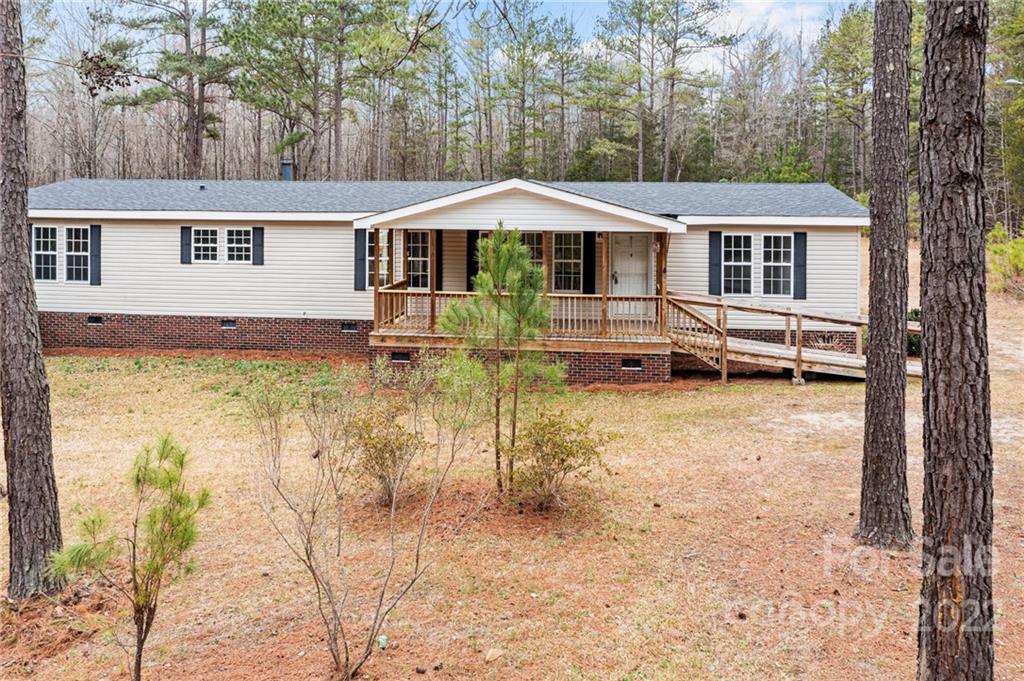 3205 Unity Church Road Lancaster, SC 29720 - Photo 32 of 45 a backyard of a house with barbeque oven table and chairs