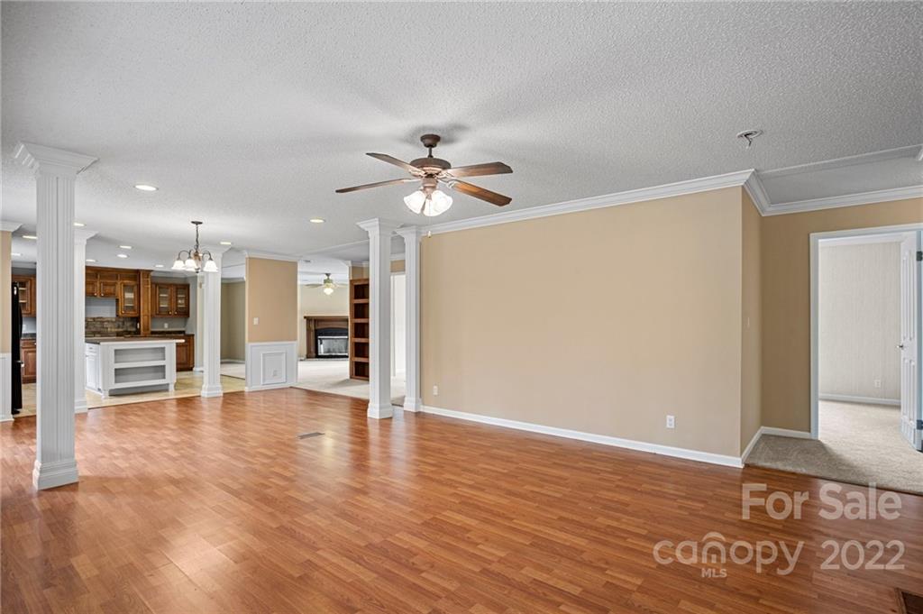 3205 Unity Church Road Lancaster, SC 29720 - Photo 7 of 45 a view of an empty room with wooden floor and a kitchen