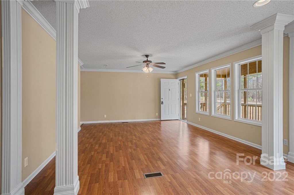 3205 Unity Church Road Lancaster, SC 29720 - Photo 8 of 45 a view of an empty room with wooden floor and a window