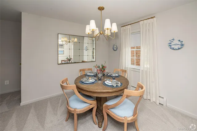 a view of a dining room with furniture and chandelier