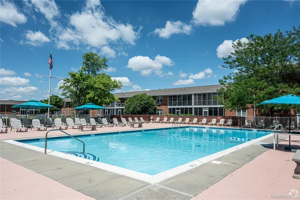 a view of a swimming pool with outdoor seating