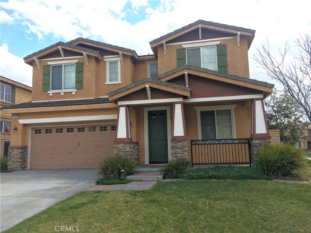 15213 Hawk Street Fontana, CA 92336 - Photo 1 of 20 a front view of a house with a yard and garage