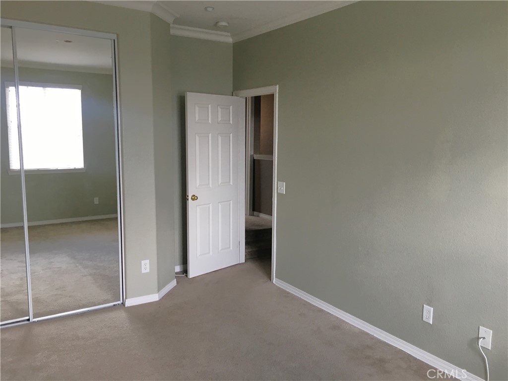 15213 Hawk Street Fontana, CA 92336 - Photo 15 of 20 a view of an empty room with closet and a window